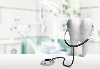 Big tooth and dentist mirror in dentist clinic on background