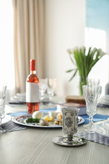 Table served for Passover (Pesach) Seder indoors, space for text