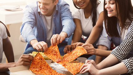 Eating pizza. Friends taking slices of pizza