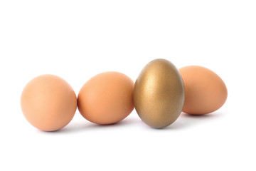 Golden egg among others on white background