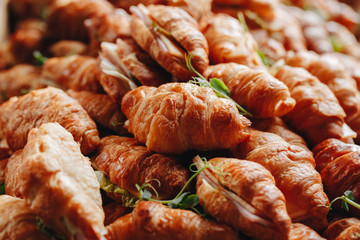 Close Up Fresh Croissants With Salad, Ham And Cheese On Table
