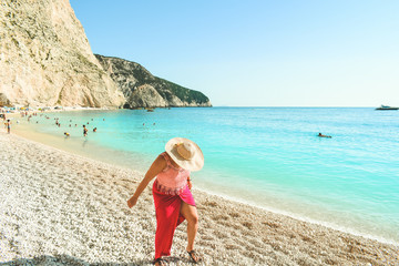 Beautiful woman walking on Porto Katskiki beach in Greece