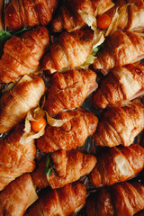 Close Up Fresh Croissants With Salad, Ham And Cheese On Table