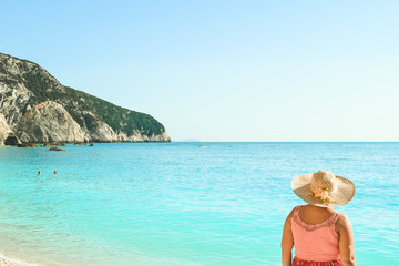 Fototapeta na wymiar Beautiful woman walking on Porto Katskiki beach in Greece