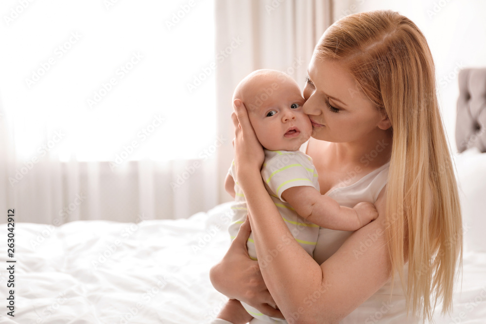 Wall mural mother with her little baby in bedroom