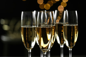 Glasses of champagne on blurred background, closeup. Space for text