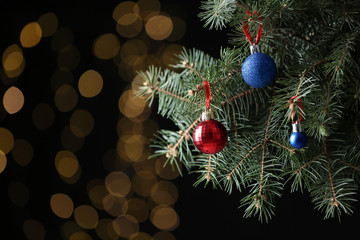 Beautifully decorated Christmas tree against blurred lights, space for text