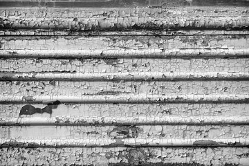 Black and white gray old cracked rusty damaged painted metal background texture close-up