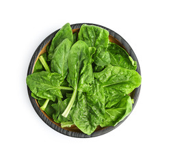 Bowl of fresh spinach leaves isolated on white, top view