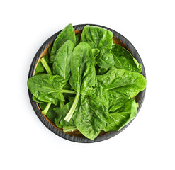 Bowl of fresh spinach leaves isolated on white, top view