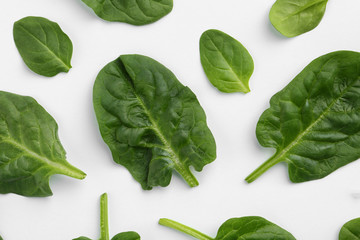 Fresh leaves of spinach isolated on white, top view