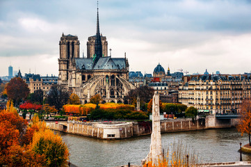 Aerial view of Notre Dam Cathedral with Seine river in autumn in Paris, France