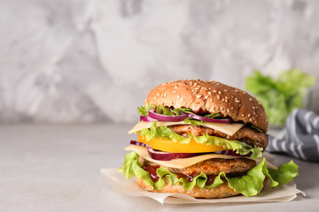 Delicious hamburger on table. Space for text