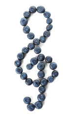 Treble clef made of bilberries on white background, top view. Creative musical notes