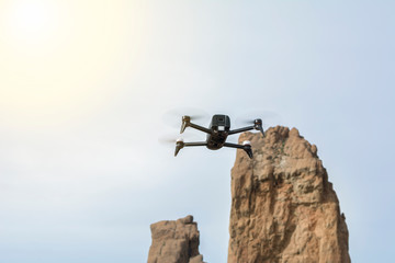 The drone flies as high as the mountain in front of it.