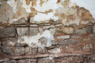 Stone wall with clay and whitewashed background texture.
