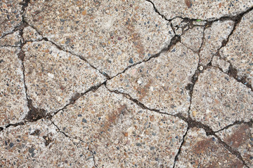 Old worn and cracked asphalt with cracks.