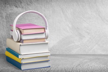 Audio book concept,books and headphones on background