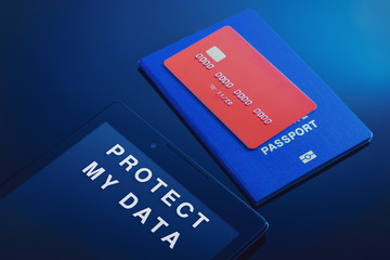 Tablet and passport with a bank card with fictitious data as a concept for the protection of personal data