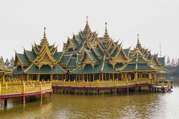 Fototapeta na wymiar Gold bridge in big pavilion on water at thailand