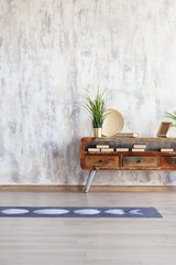 Yoga studio with yoga mat, bedside table with plants, books and decor. Background. Full-size composition.
