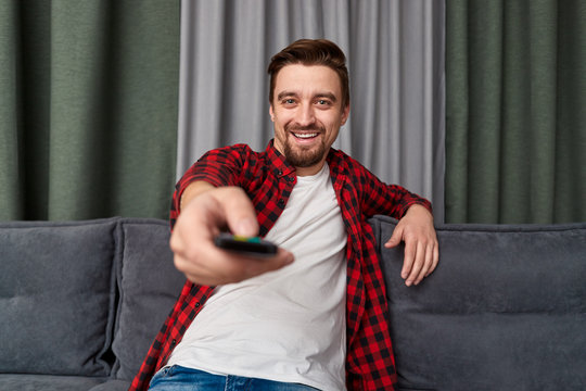 Relaxed male watching TV on sofa