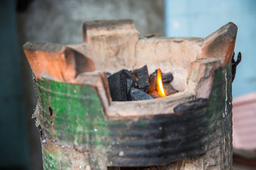 Thai stove, cooking tool. Traditional charcoal burning clay stove in a rustic wooden house.