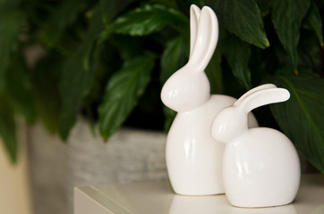 Two white ceramic Easter bunnies