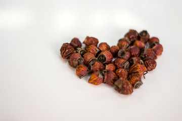 rose hips laid out heart