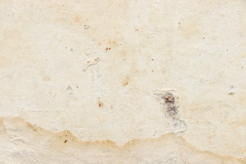 Blank dirty cardboard and paper background. The texture of the surface of old cardboard in stains and the blank background of the old book sheet. 