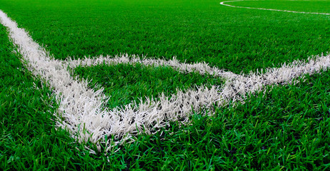 Artificial turf soccer field with corner marker line. © Nudphon
