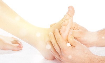 Male hands massaging foot on white background