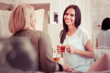 Joyful longhaired brunette looking at her interlocutor