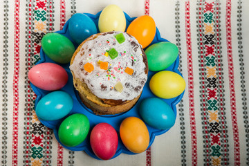 top view of decorated easter bread and dyed easter eggs