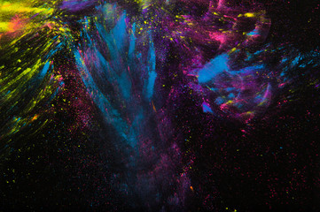 Colorful powder on black background. Abstract print. Holi paint
