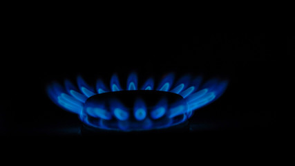 blue flames of gas burning in the dark