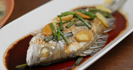 Steamed fish on dish at home