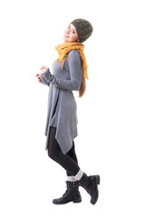 Side view of happy smiling unique style hipster girl with shawl and woolly cap posing. Full body isolated on white background. 