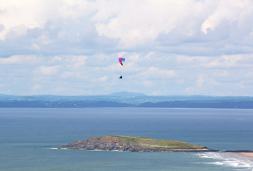 Paraglider flying at Rhossili, Wales