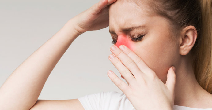 Young woman tired, rubbing nose and eyes