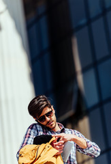 Obraz premium Front view of a happy man calling on the phone walking on the street