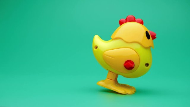 Clockwork chick toy hopping around. Slow motion.