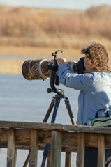 Woman Shooting With Large Camera Lens