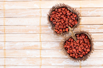 Annatto seeds on rustic wood