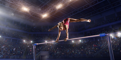 Female athlete doing a complicated exciting trick on horizontal gymnastics bars in a professional gym. Girl perform stunt in bright sports clothes - obrazy, fototapety, plakaty