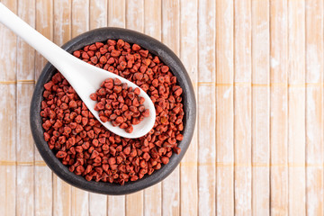 Annatto seeds on rustic wood