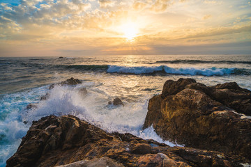 Fototapeta na wymiar Ocean scenery, powerful waves and a colorful sunset in Portugal