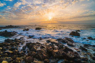 Ocean scenery, powerful waves and a colorful sunset in Portugal