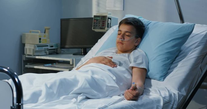Teenager boy lying in hospital
