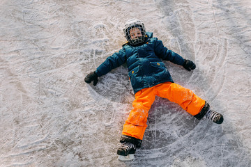 Boy making snow angel